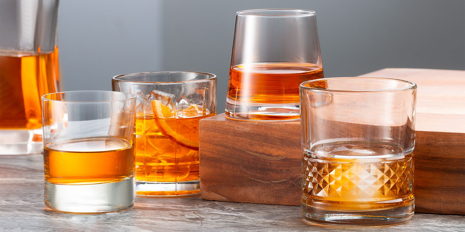 Four whiskey glasses on table